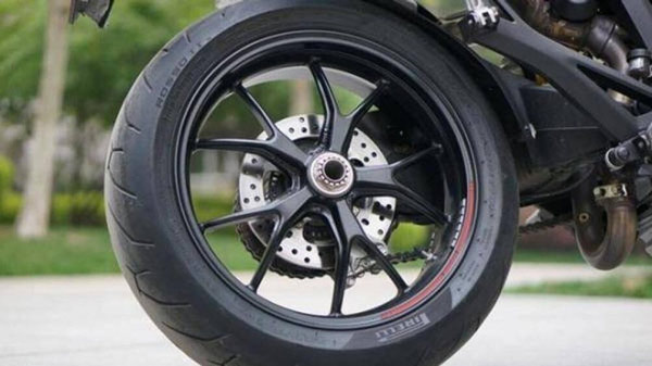 The rear tire of a motorbike is usually wider than the front tire